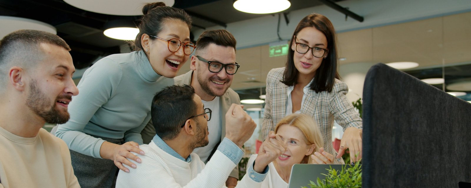A team celebrating a good result at the office